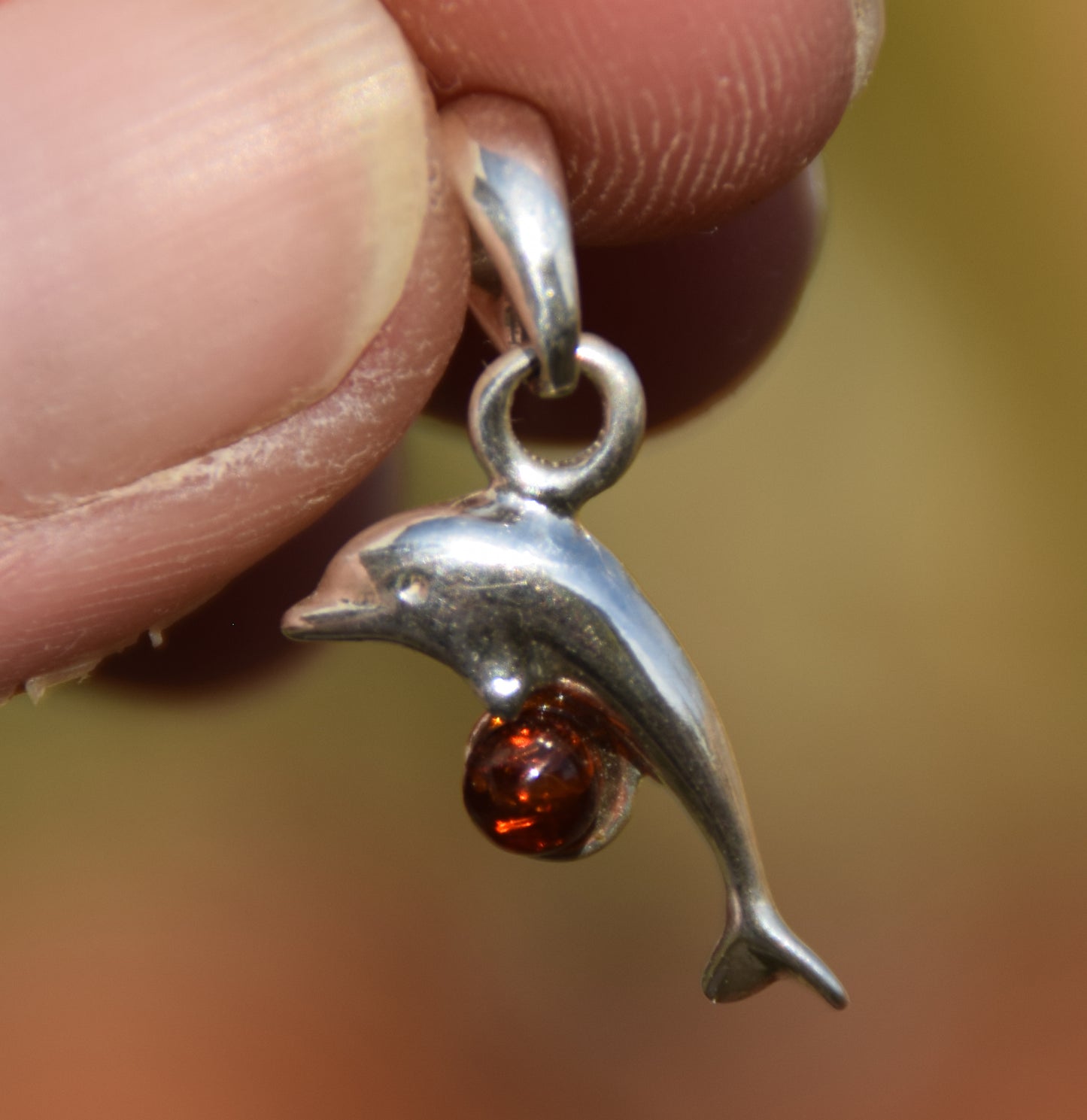 Delicate pendant with a joyful dolphin in cognac-colored natural Amber and 925 Silver, MJ Baltica, BW315