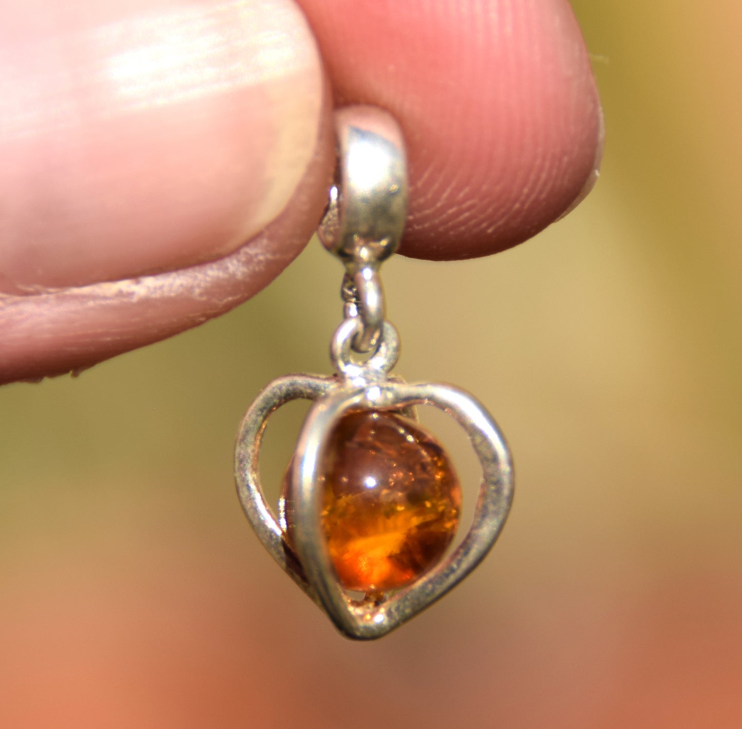 Delicate pendant with a cage-shaped heart in cognac-colored natural Amber and 925 Silver, MJ Baltica, BW318