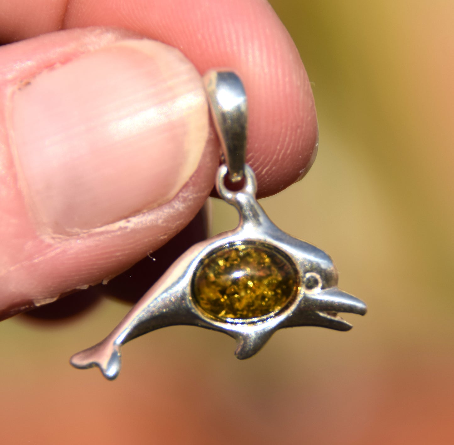 Delicate pendant with a joyful dolphin in natural green amber and 925 silver, MJ Baltica, BW320