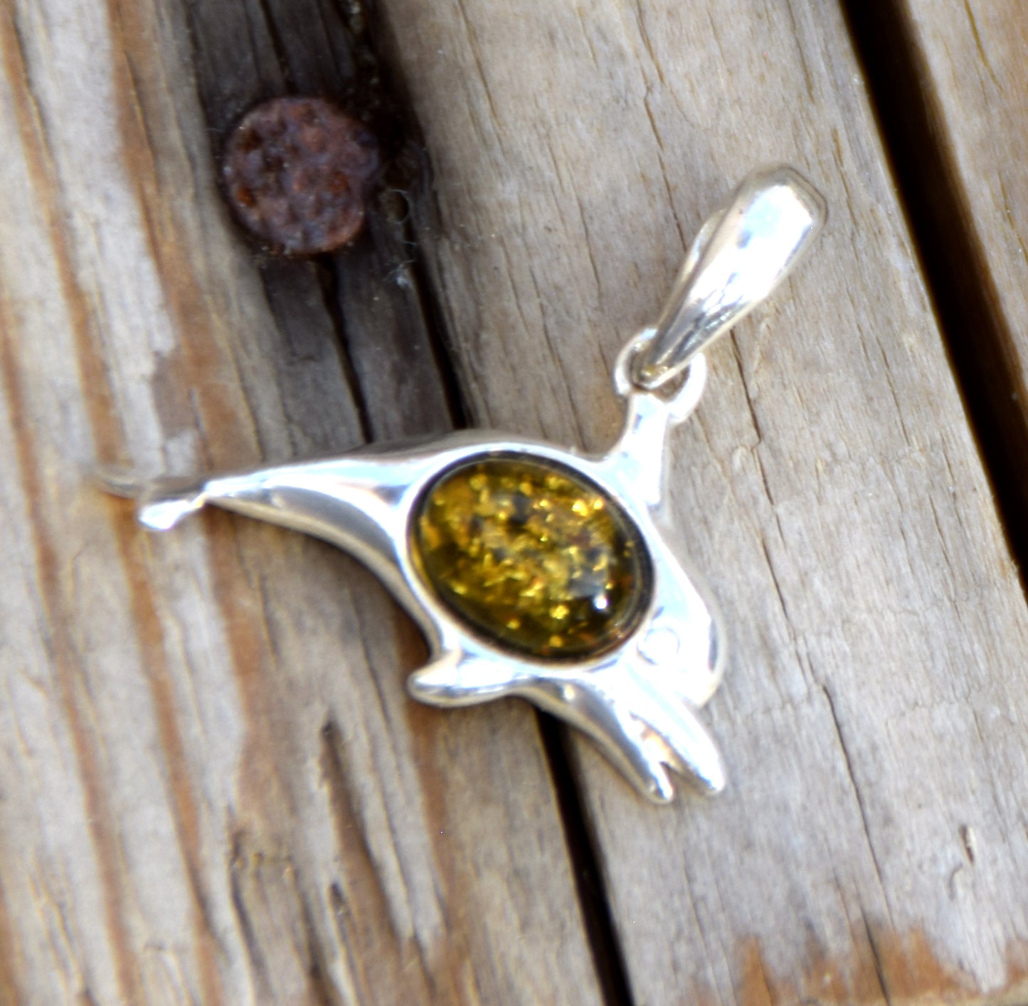 Delicate pendant with a joyful dolphin in natural green amber and 925 silver, MJ Baltica, BW320