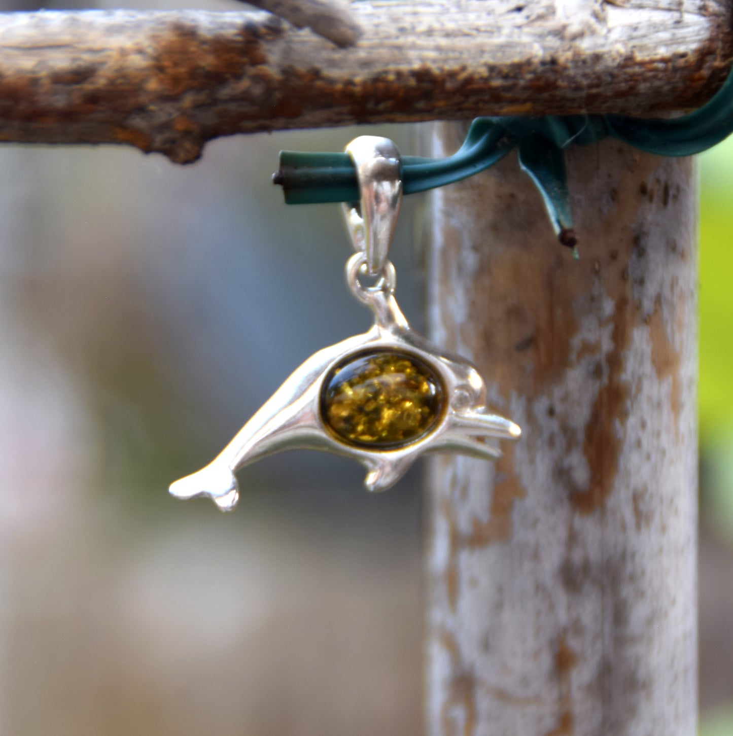 Delicate pendant with a joyful dolphin in natural green amber and 925 silver, MJ Baltica, BW320