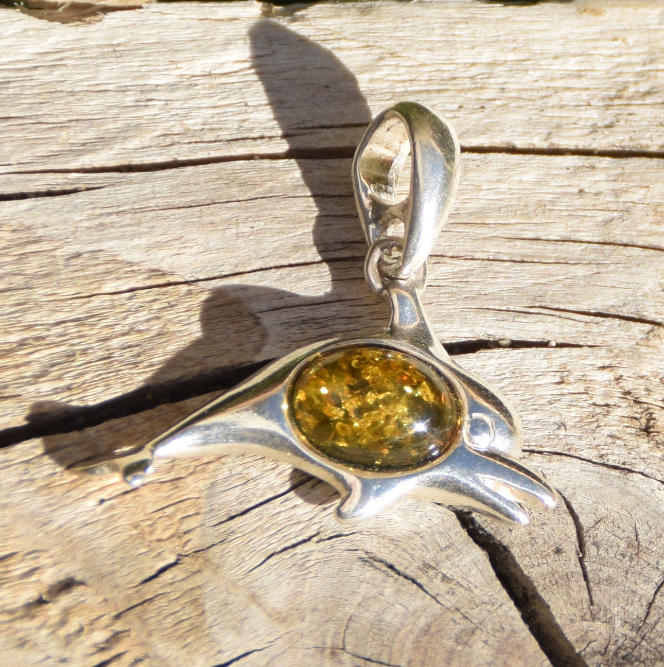 Delicate pendant with a joyful dolphin in natural green amber and 925 silver, MJ Baltica, BW320