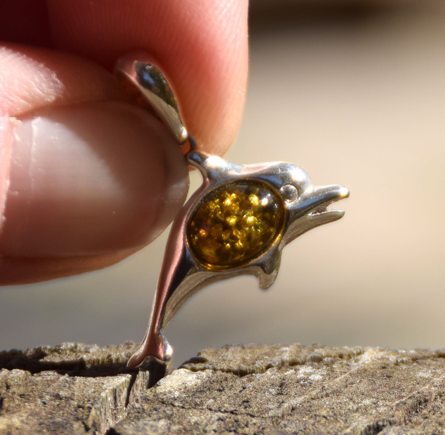 Delicate pendant with a joyful dolphin in natural green amber and 925 silver, MJ Baltica, BW320