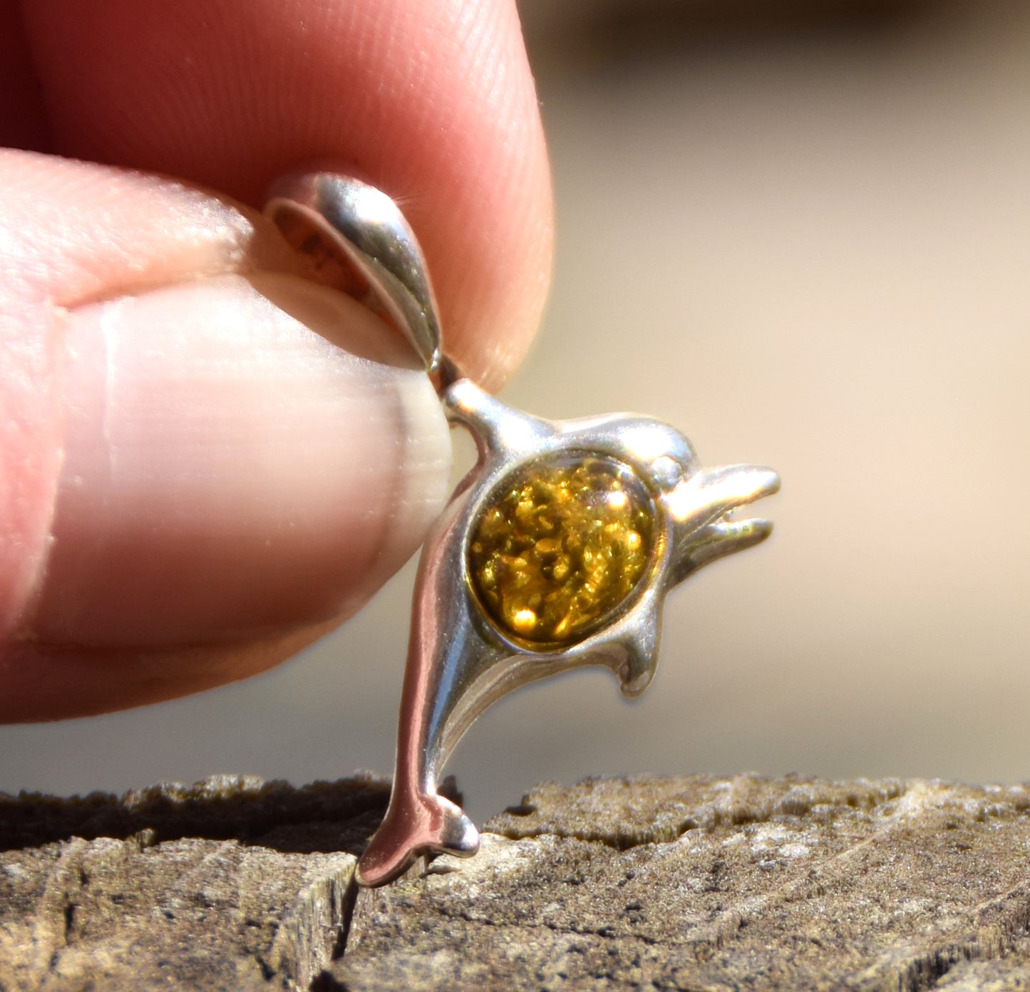Delicate pendant with a joyful dolphin in natural green amber and 925 silver, MJ Baltica, BW320