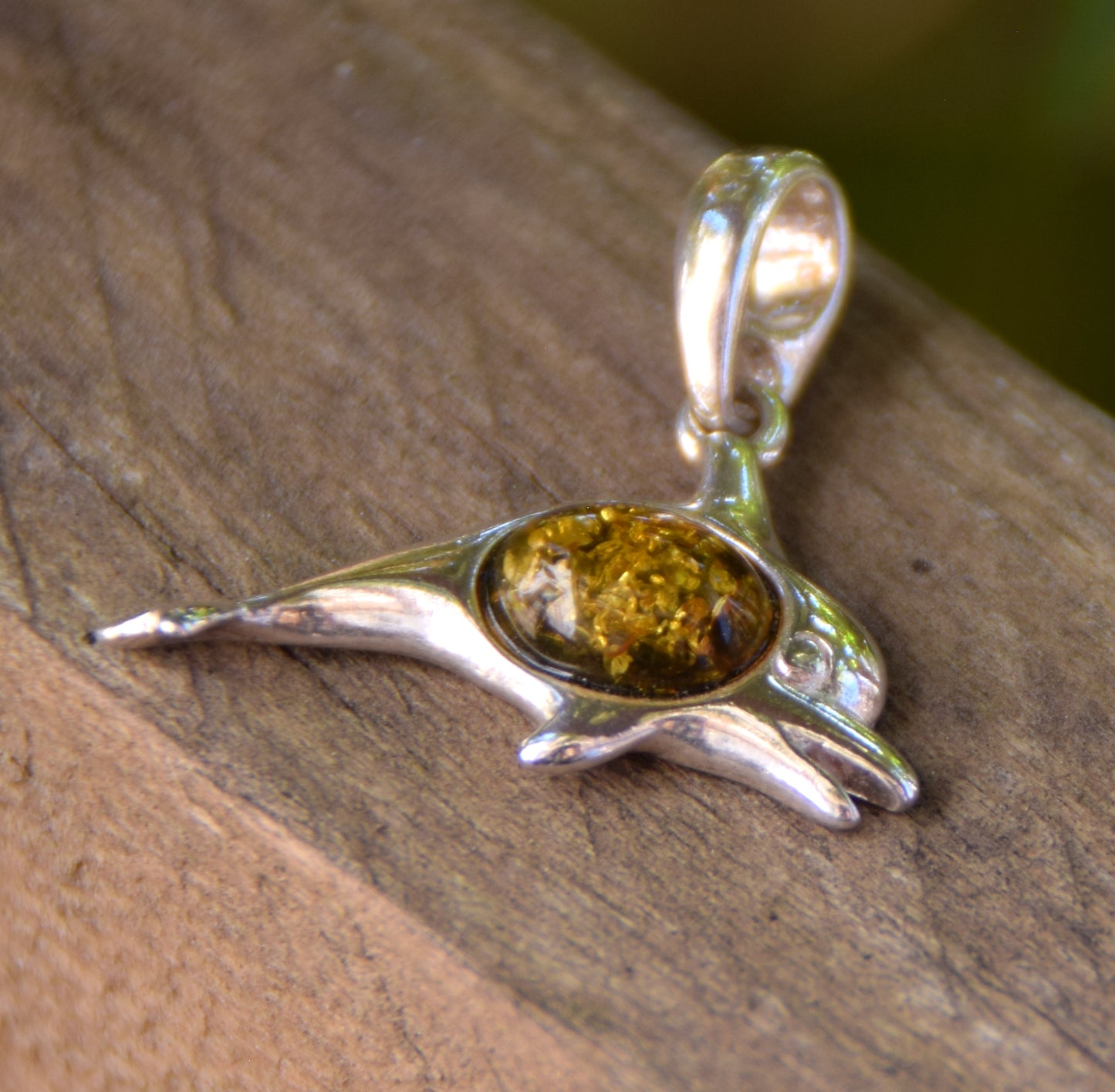 Delicate pendant with a joyful dolphin in natural green amber and 925 silver, MJ Baltica, BW320