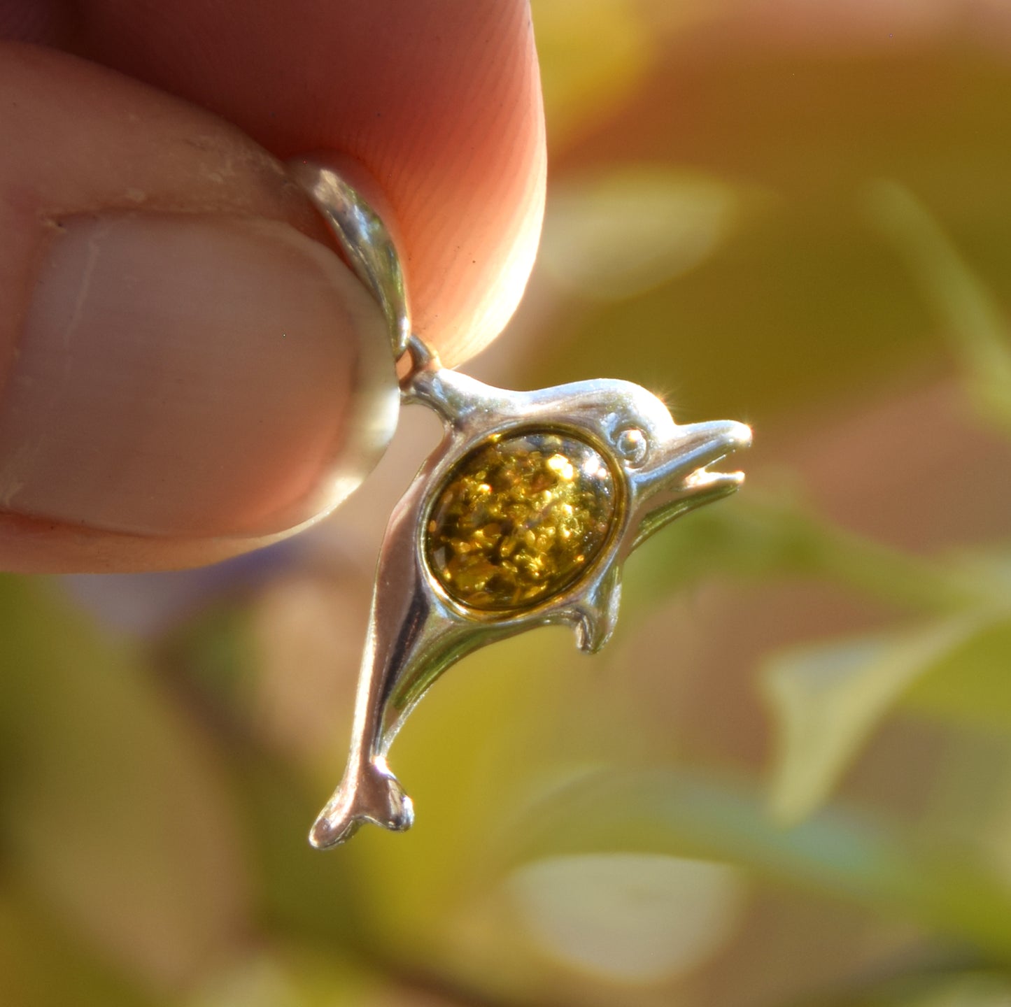 Delicate pendant with a joyful dolphin in natural green amber and 925 silver, MJ Baltica, BW320