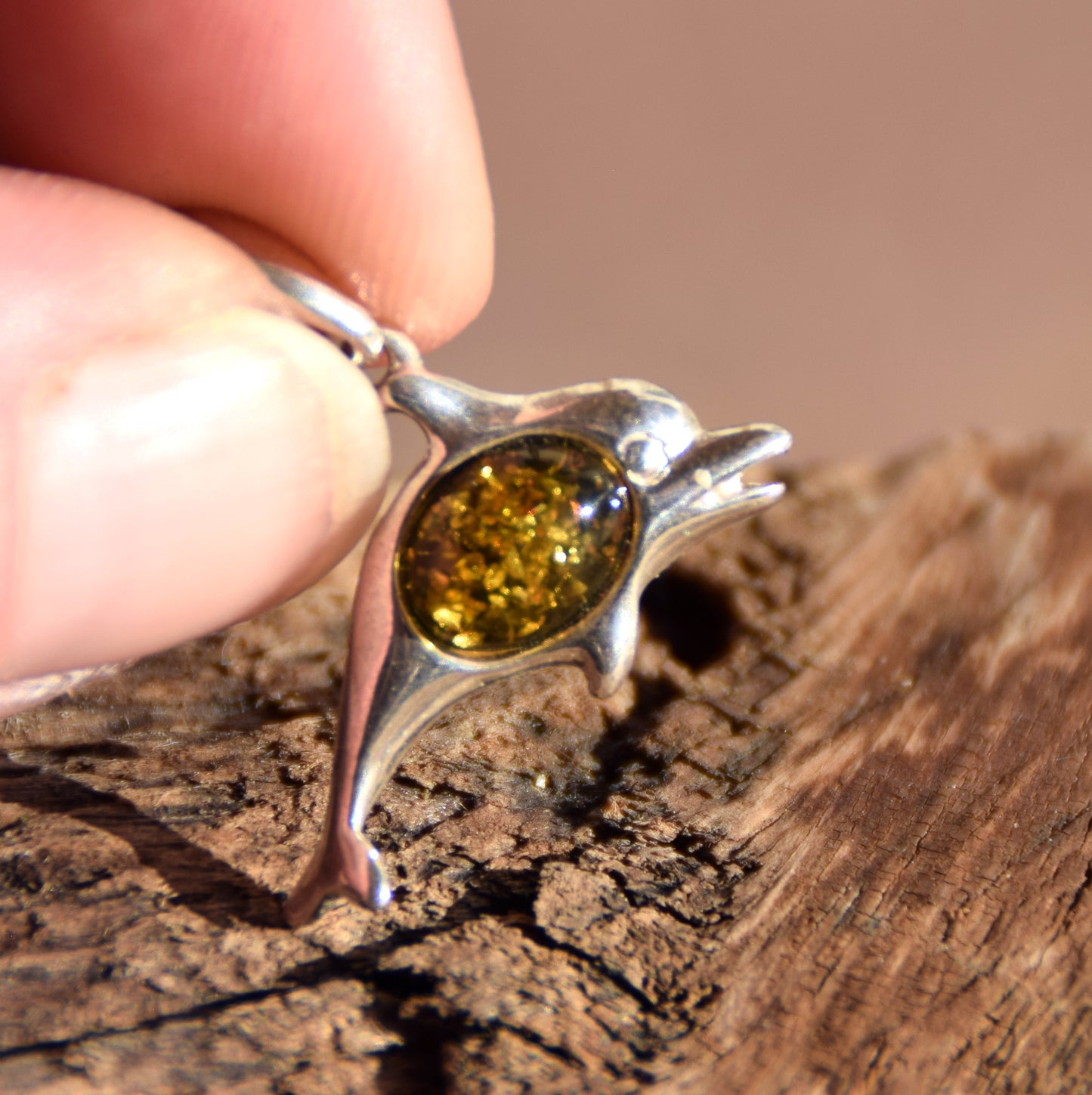 Delicate pendant with a joyful dolphin in natural green amber and 925 silver, MJ Baltica, BW320