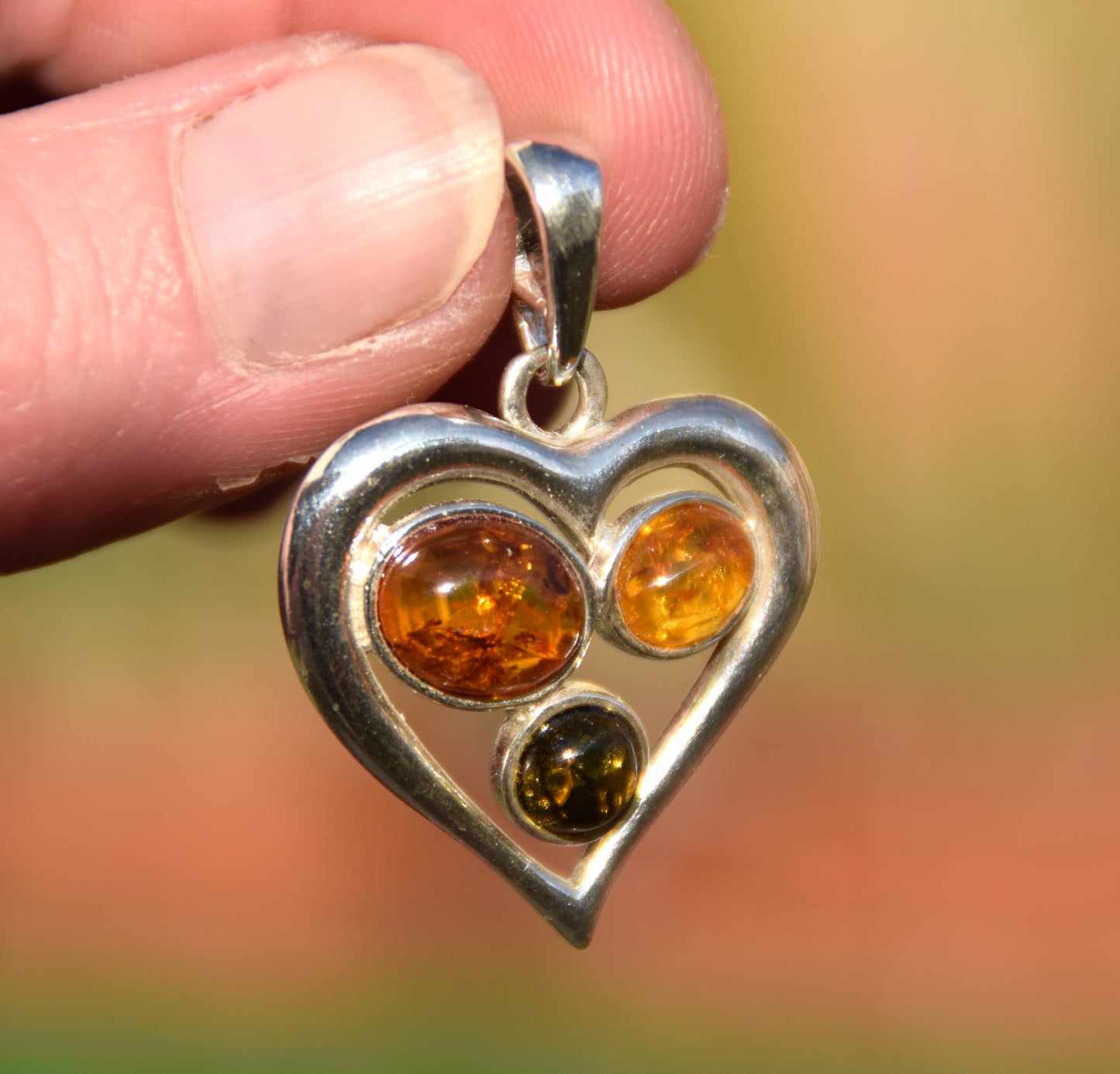 Romantic heart-shaped pendant with natural Amber of various shades and 925 Sterling Silver, MJ Baltica, BW330