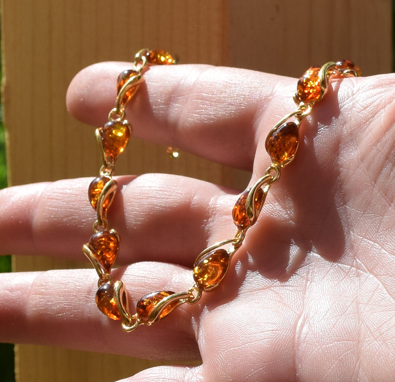 Luminous bracelet with cognac-colored natural Amber drops and 18k Gold-plated 925 Sterling Silver, MJ Baltica, BZB020