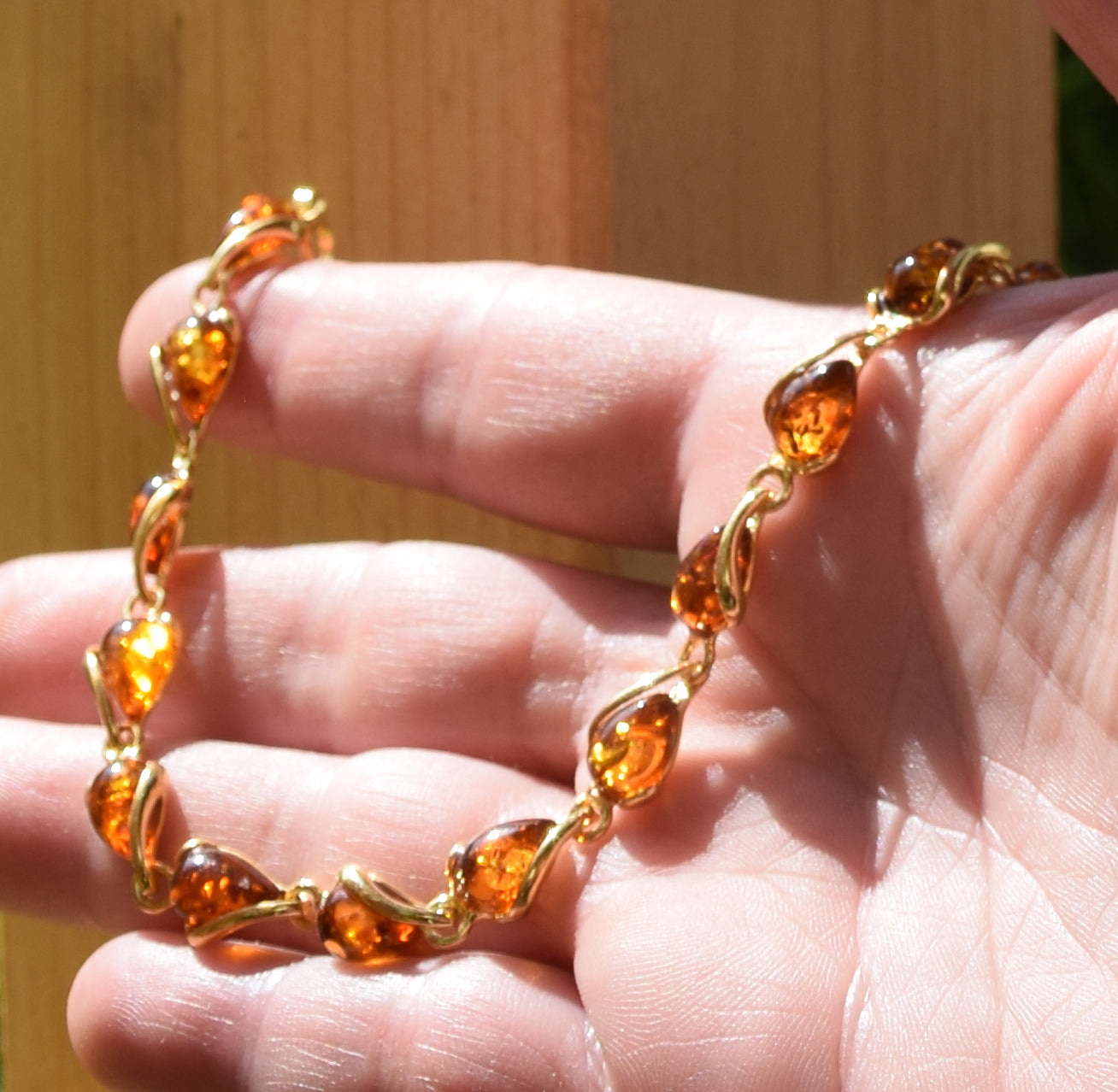 Luminous bracelet with cognac-colored natural Amber drops and 18k Gold-plated 925 Sterling Silver, MJ Baltica, BZB020