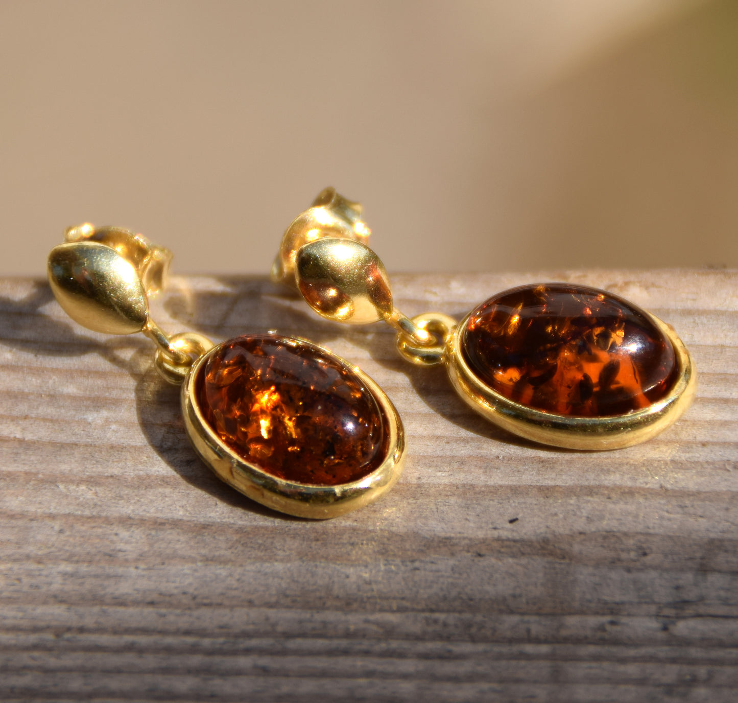 Elegant oval earrings in natural cognac Amber and 18k Gold plated 925 Sterling Silver, MJ Baltica, BZK171