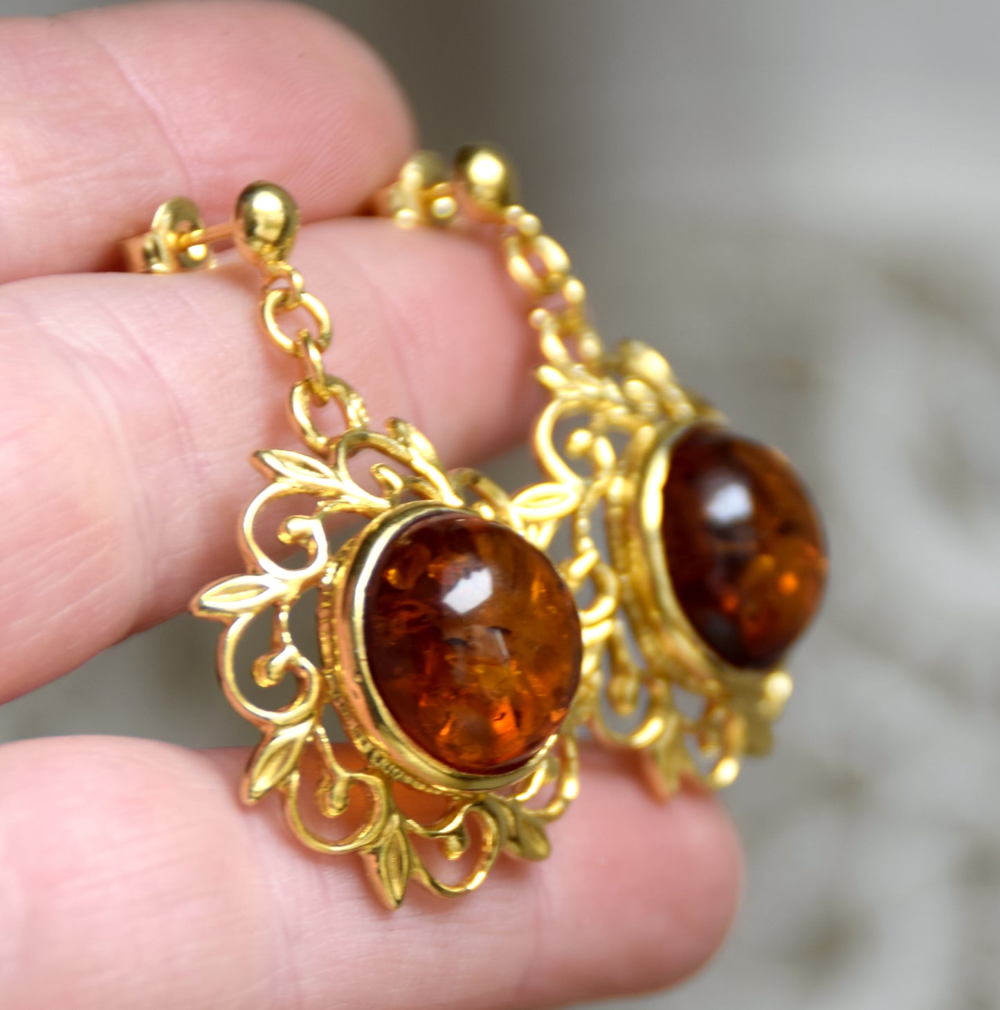 Elegant round floral earrings crafted from natural cognac amber and 18k gold-plated 925 sterling silver, MJ Baltica, BZK180