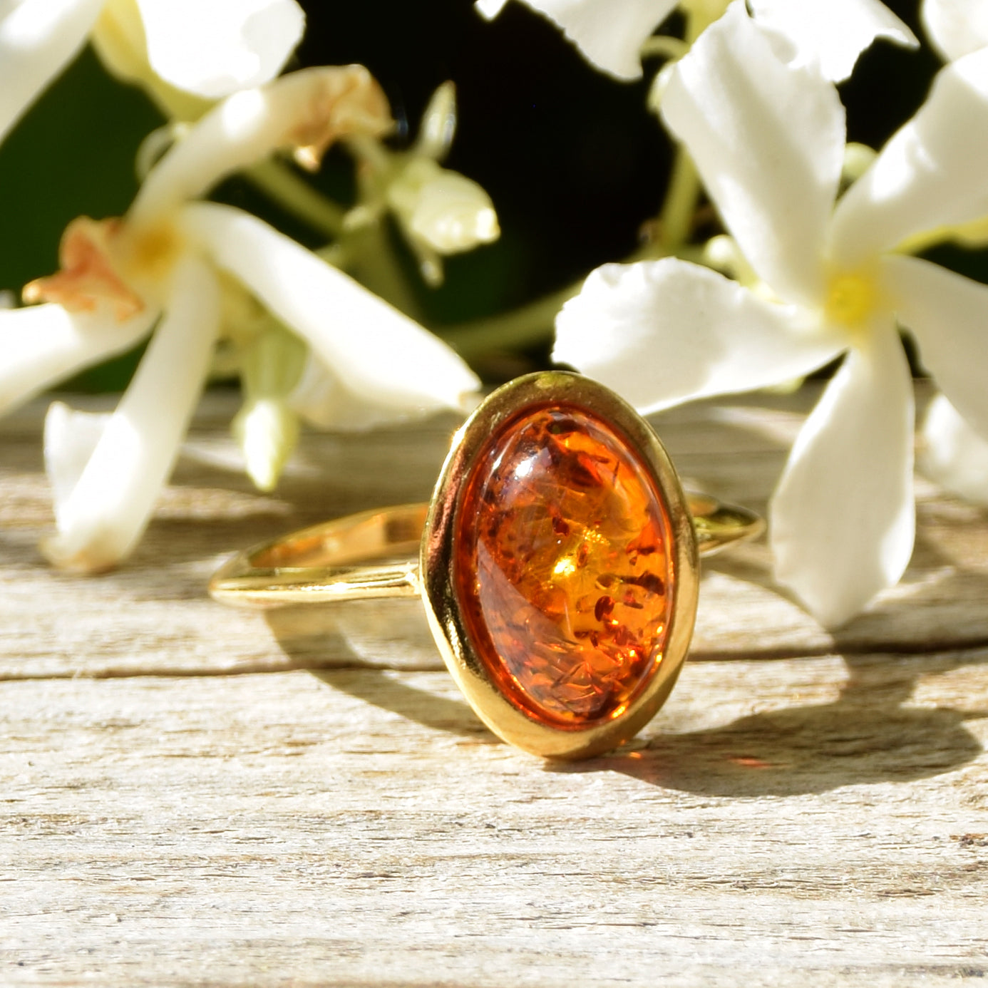 Luminous ring in an essential style with natural cognac-colored Amber and 18k Gold plated Sterling Silver, MJ Baltica, BZP013