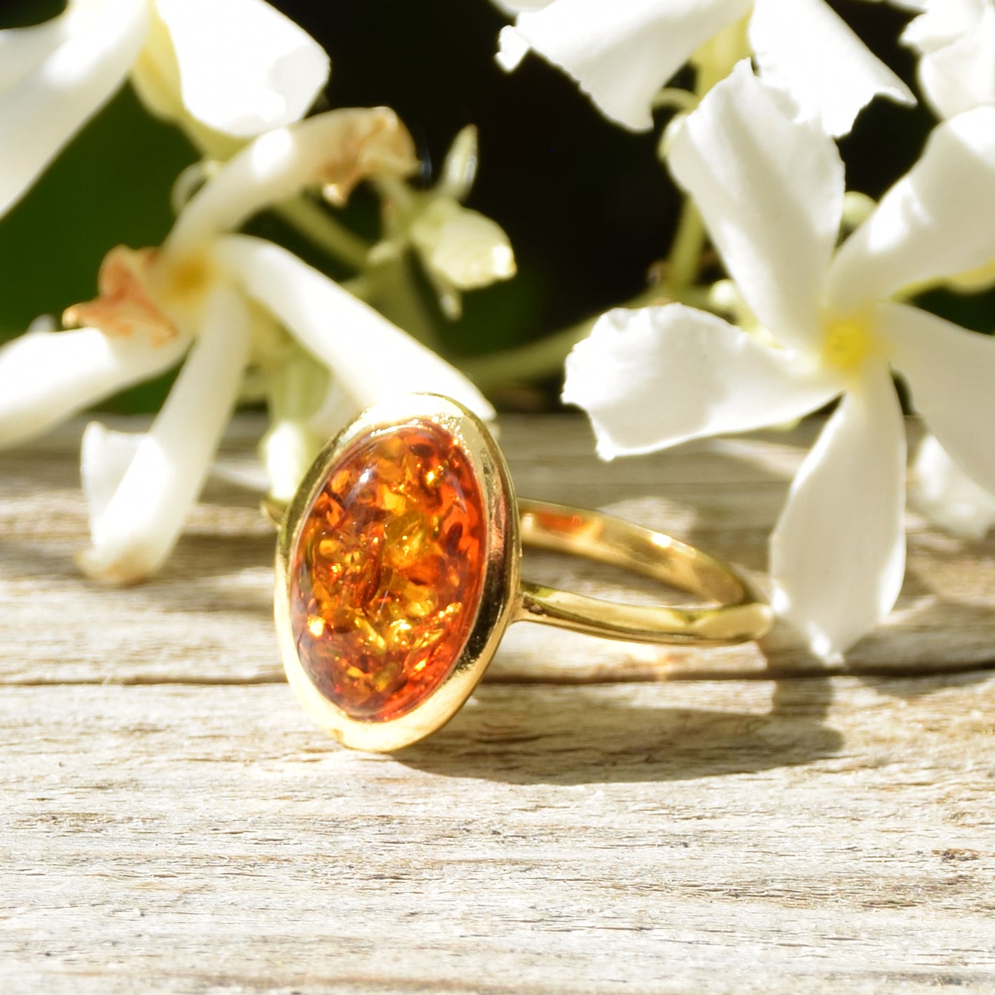 Luminous ring in an essential style with natural cognac-colored Amber and 18k Gold plated Sterling Silver, MJ Baltica, BZP013