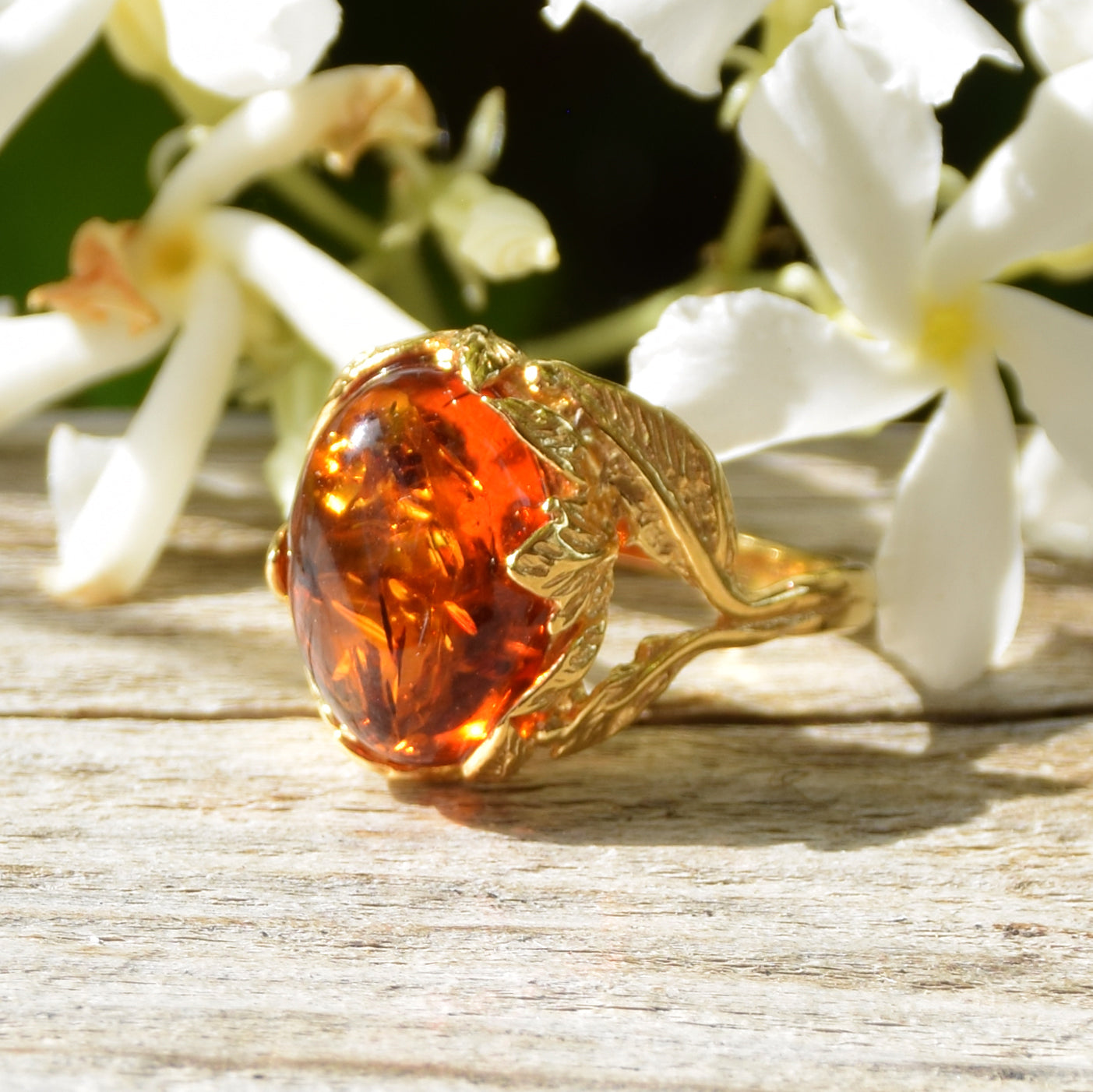 Vintage-style oval ring with floral decoration crafted from cognac-colored Natural Amber and 14k Gold-plated Silver, MJ Baltica, BZP025