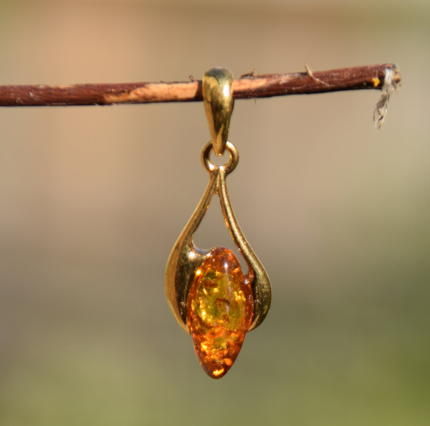 Luminous teardrop pendant in natural cognac-colored Amber and 18k Gold-plated 925 Sterling Silver, MJ Baltica, BZW071